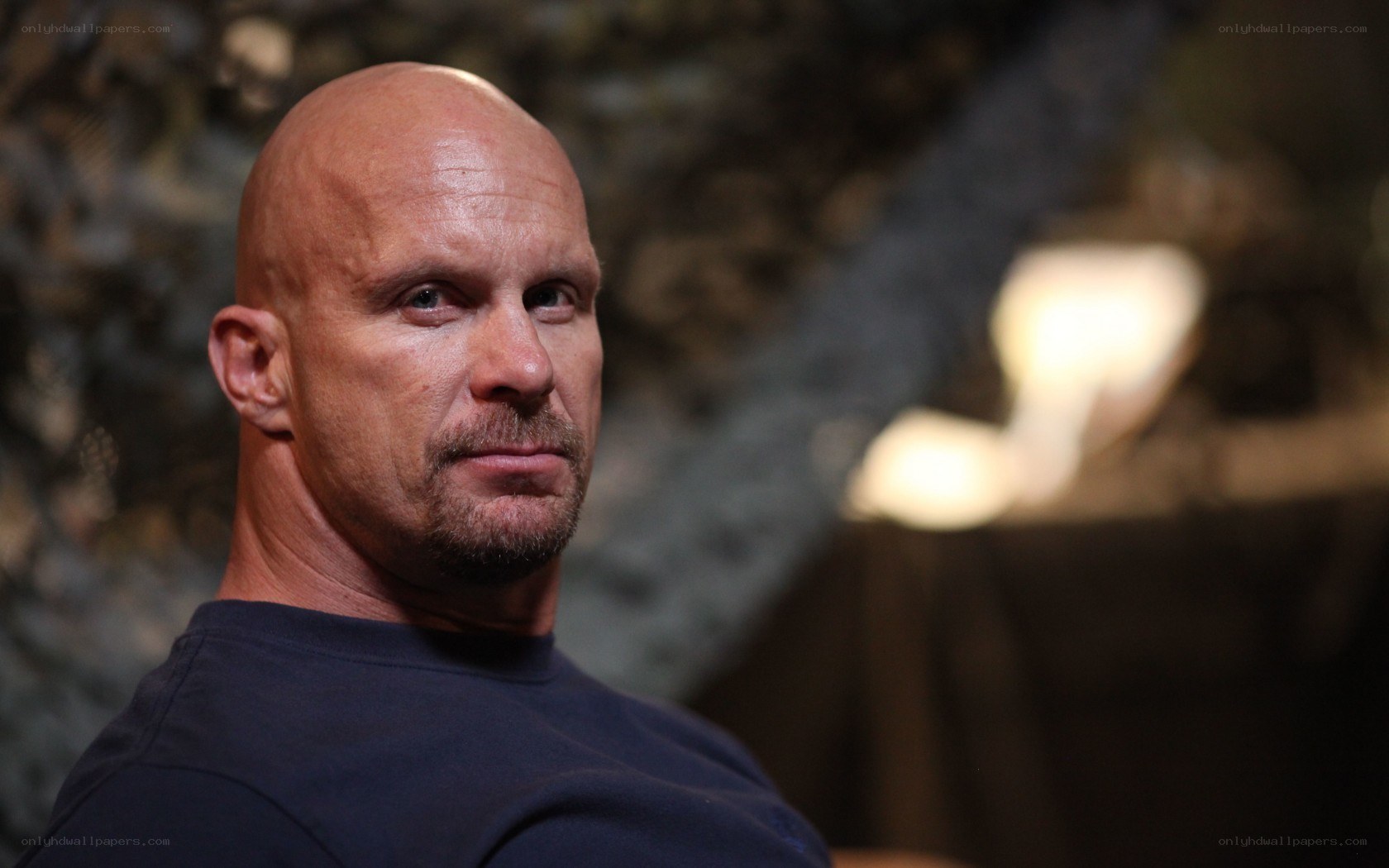 bald man in dark shirt