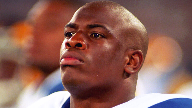 Bald Man in Football Uniform