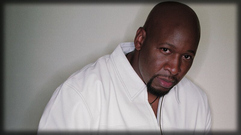 Bald Man in White Shirt — Serious