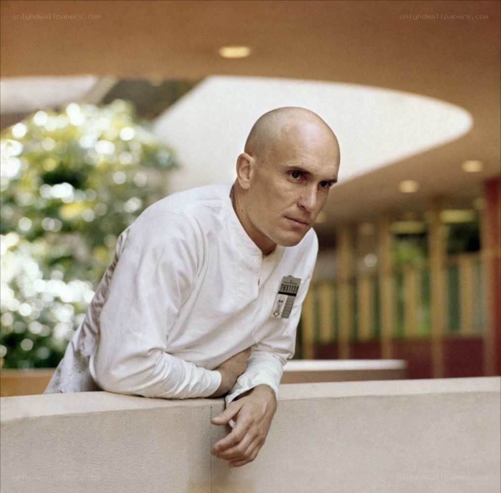 bald man in white shirt