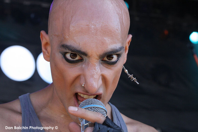 Bald Man Singing into Microphone