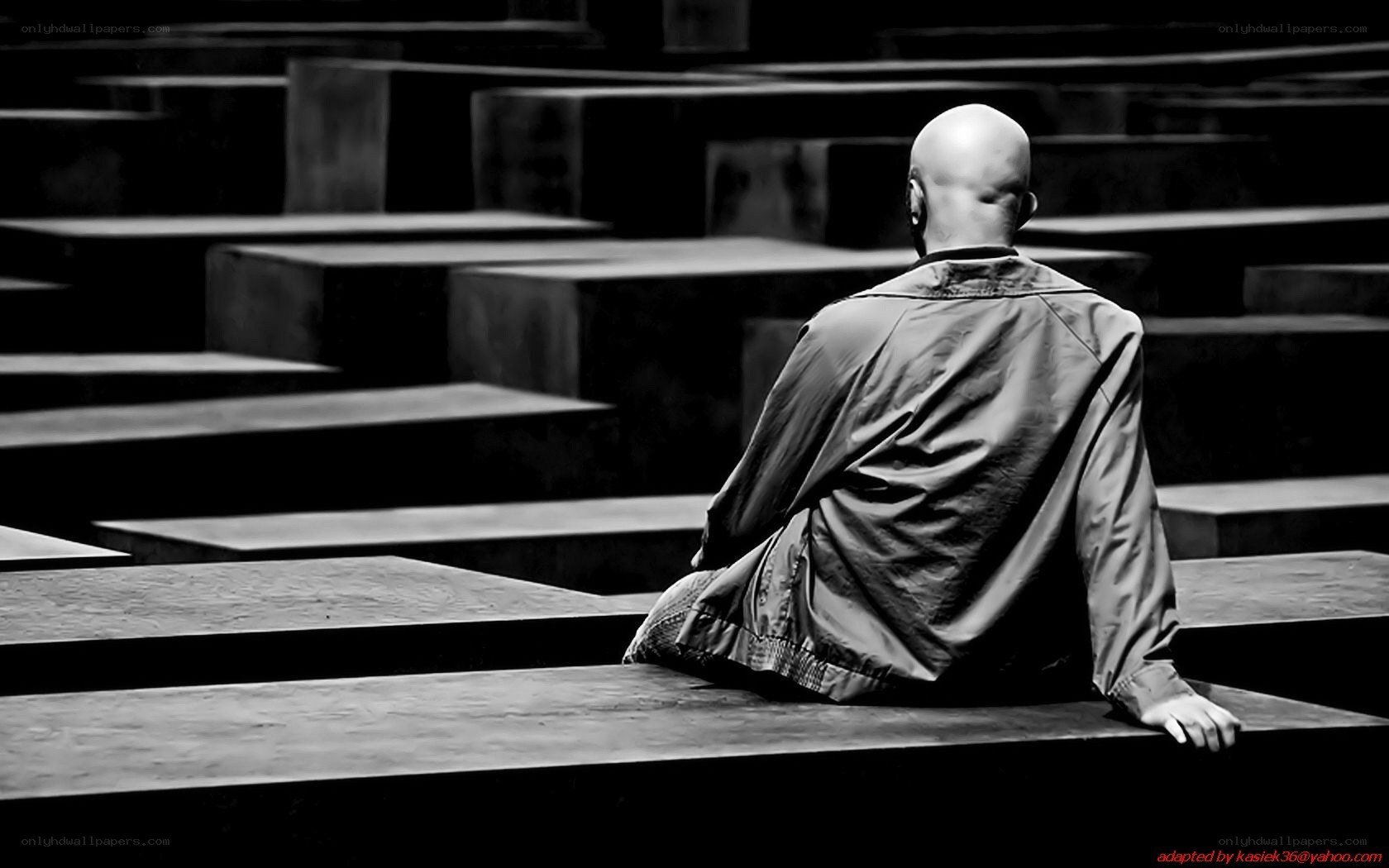 Bald man sitting in a memorial