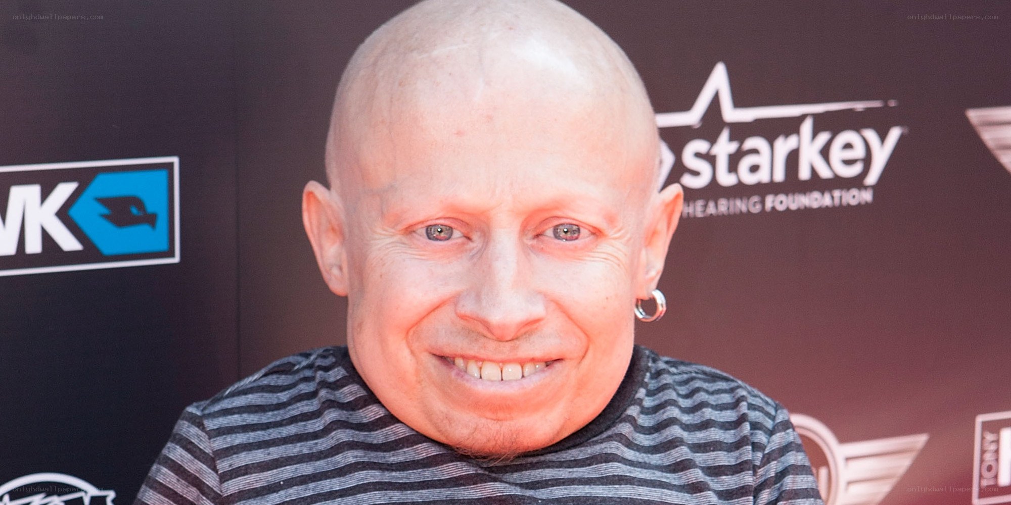 Bald man smiling at event