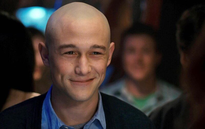 bald man smiling in crowd