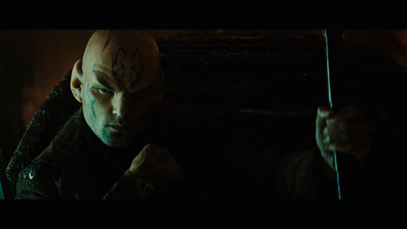 bald man with face tattoos