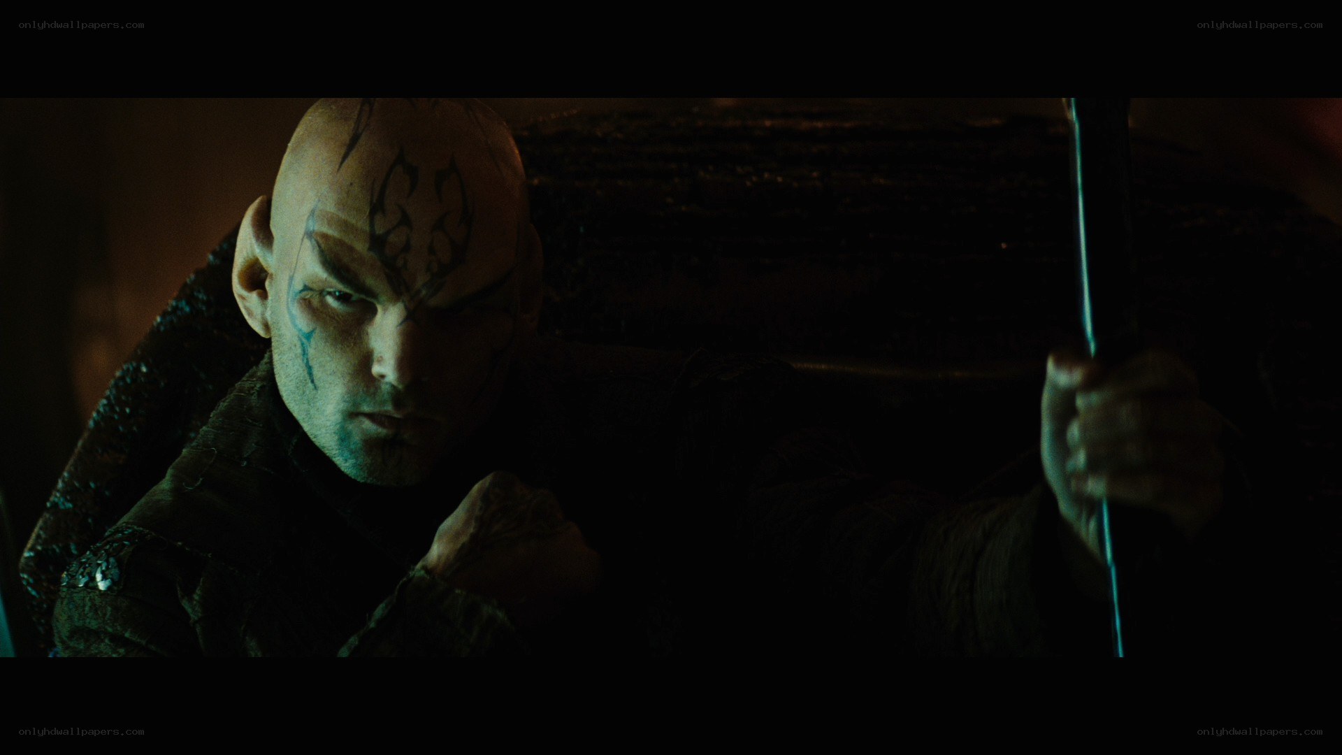 bald man with face tattoos