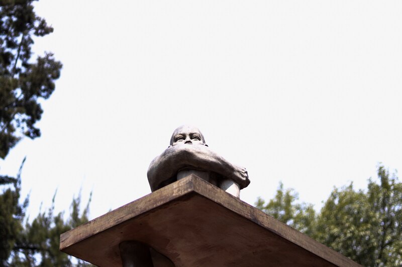 Bald Statue on Pedestal