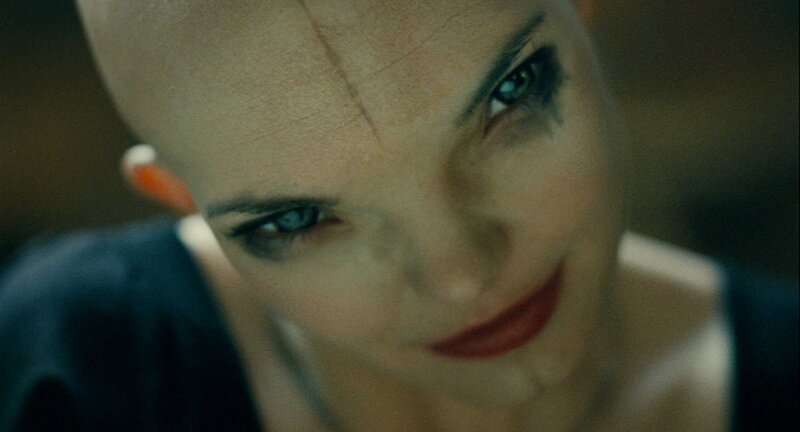 bald woman with blue eyes