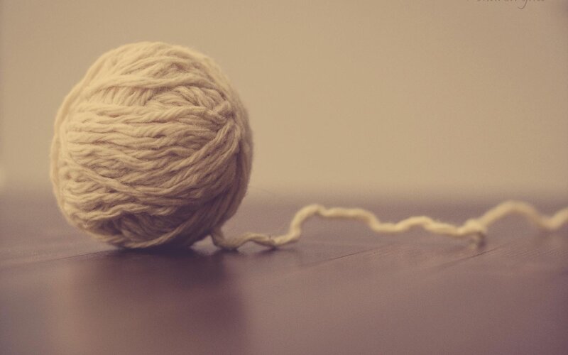 ball of yarn on wooden surface