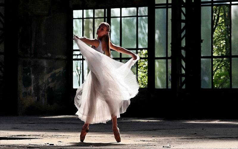 Ballerina in a sunlit warehouse
