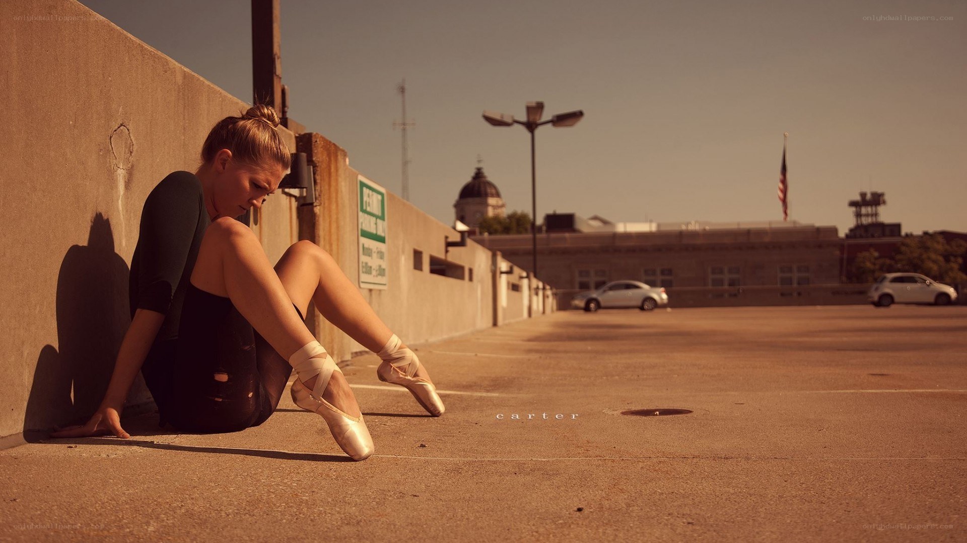 Ballerina resting in parking lot