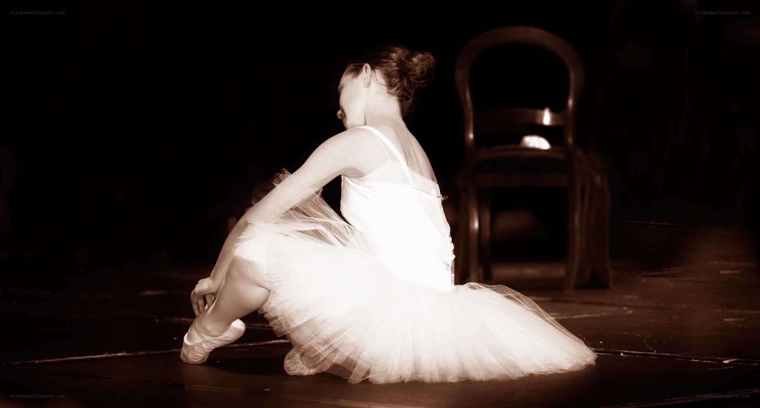 Ballerina sitting on stage