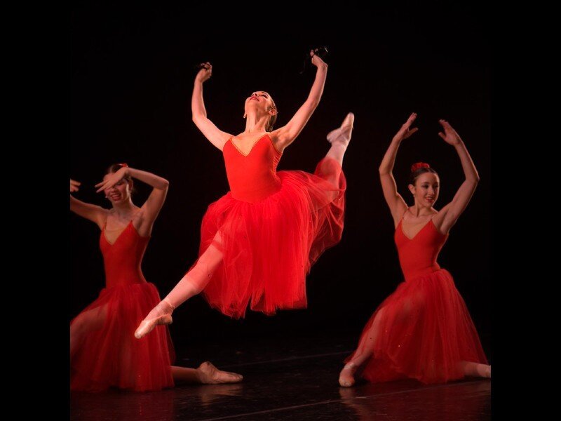 Ballerinas in red performing