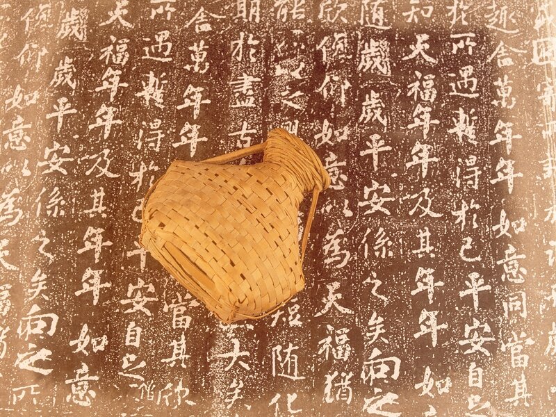 Bamboo basket on calligraphy