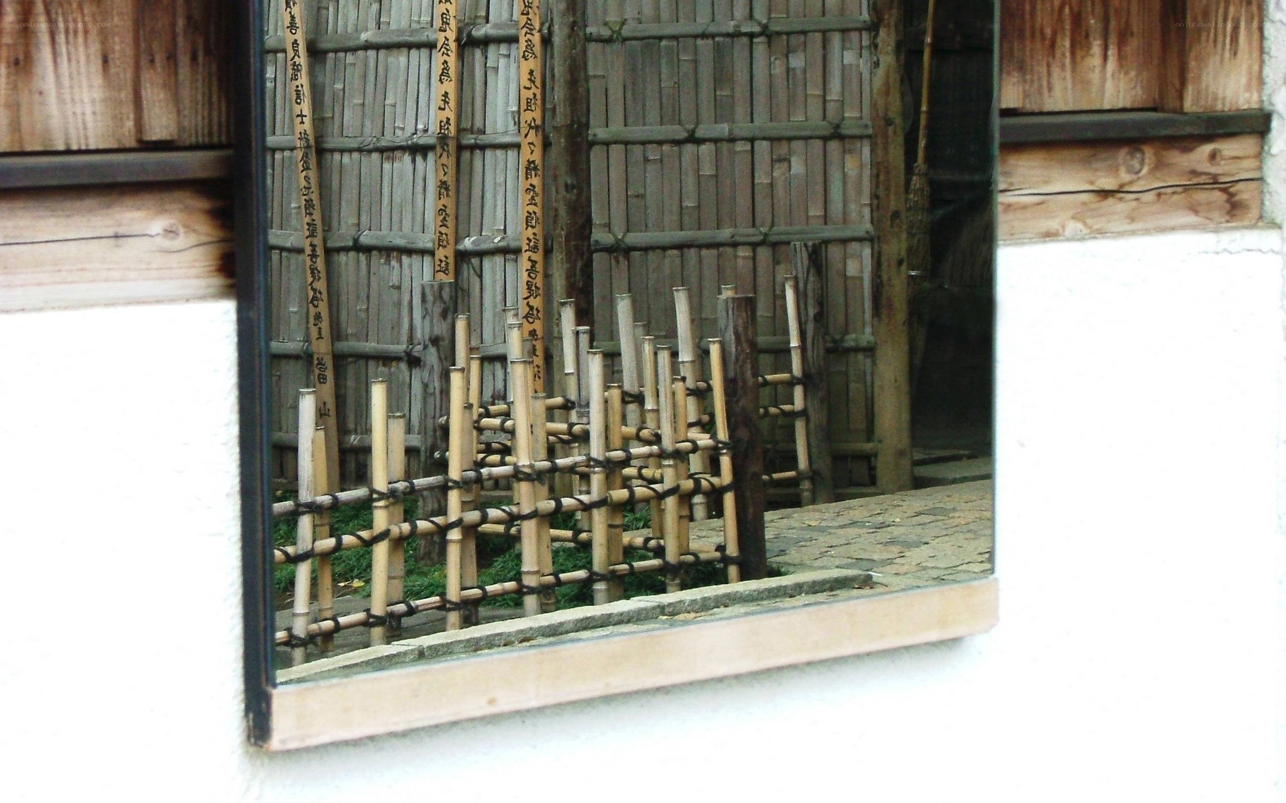 Bamboo fence reflected in a mirror