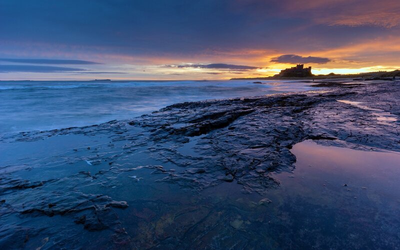 Bamburgh Castle at Sunset — Blue, Dramatic, Photograph, Ocean, Sky, Orange