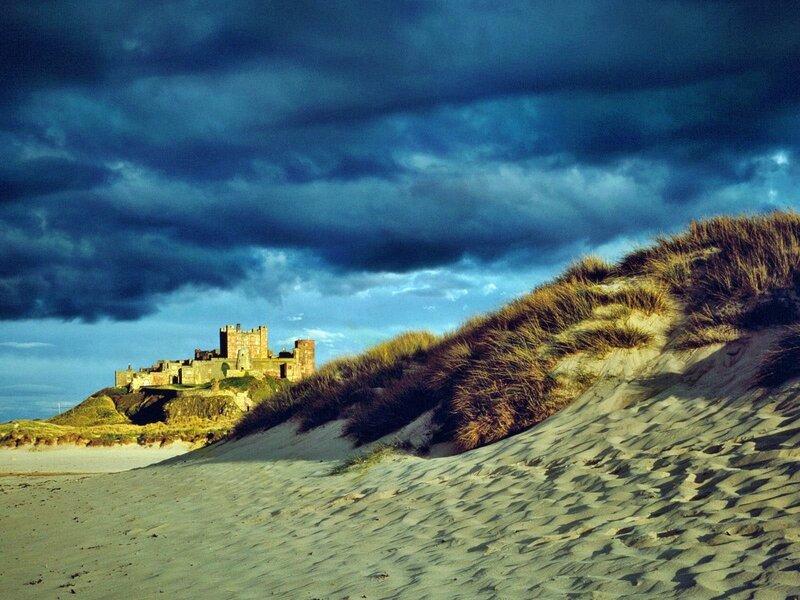 Bamburgh Castle under stormy sky