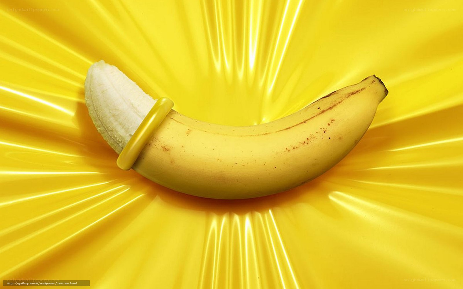 banana with condom on yellow background