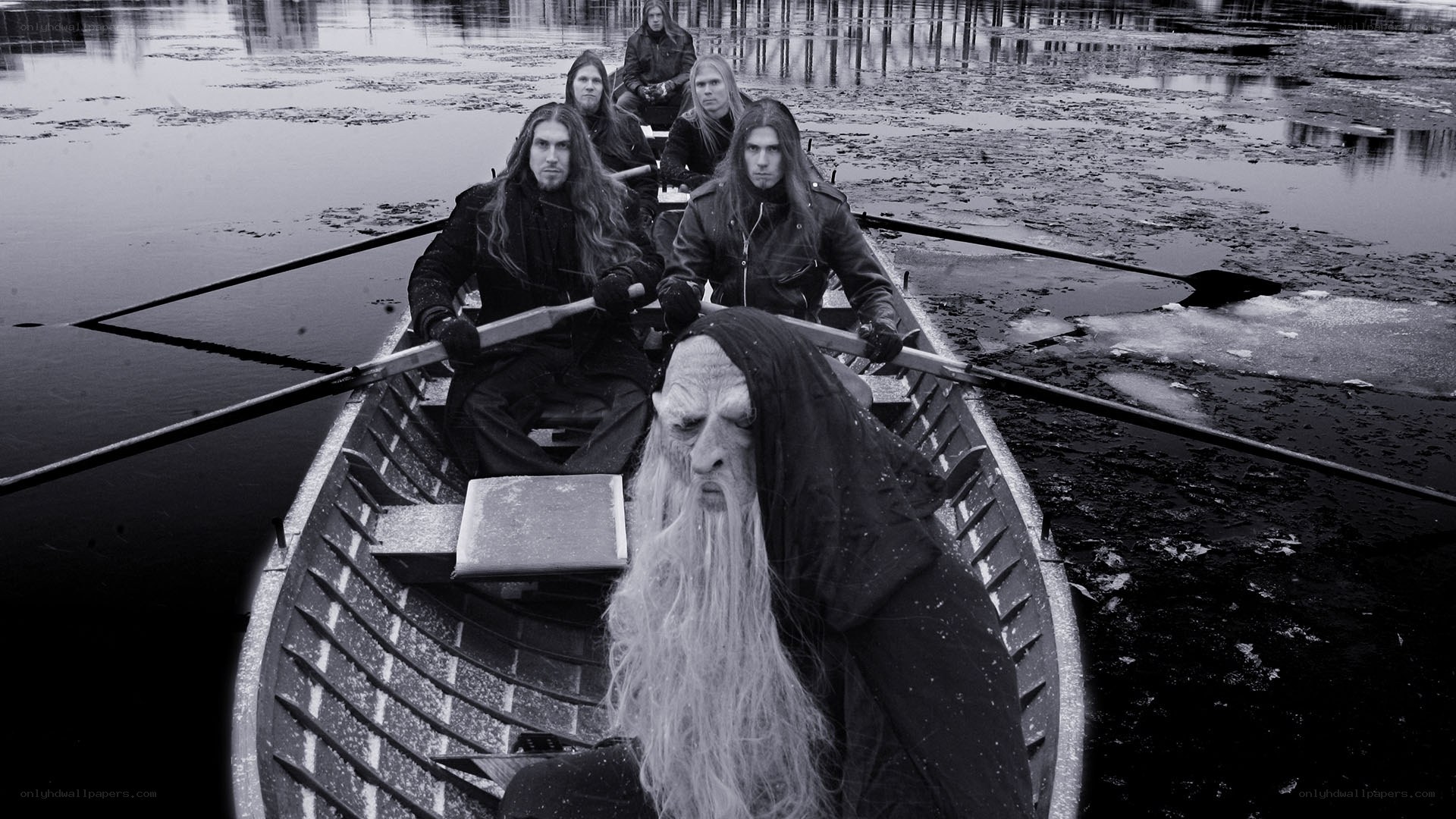 band in a boat with a hooded figure