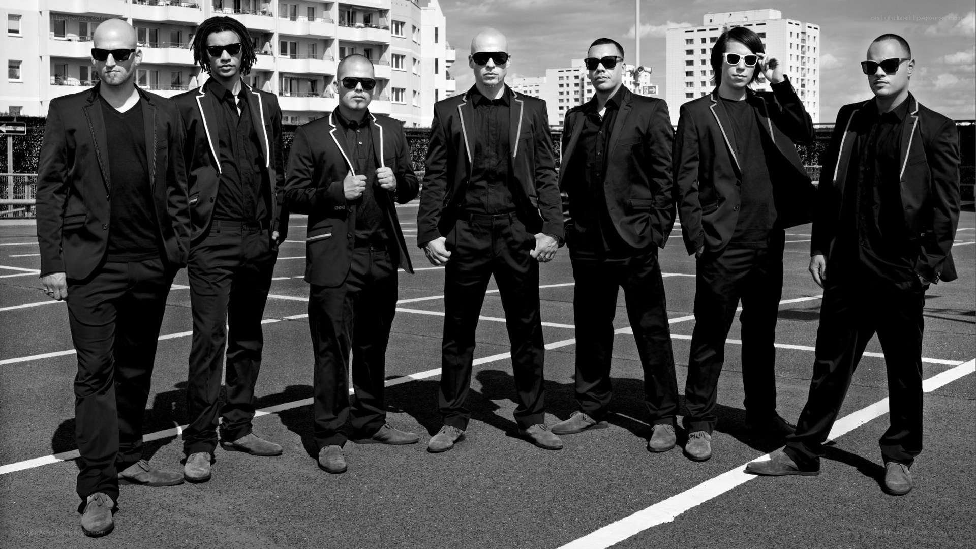 band in black suits on parking lot