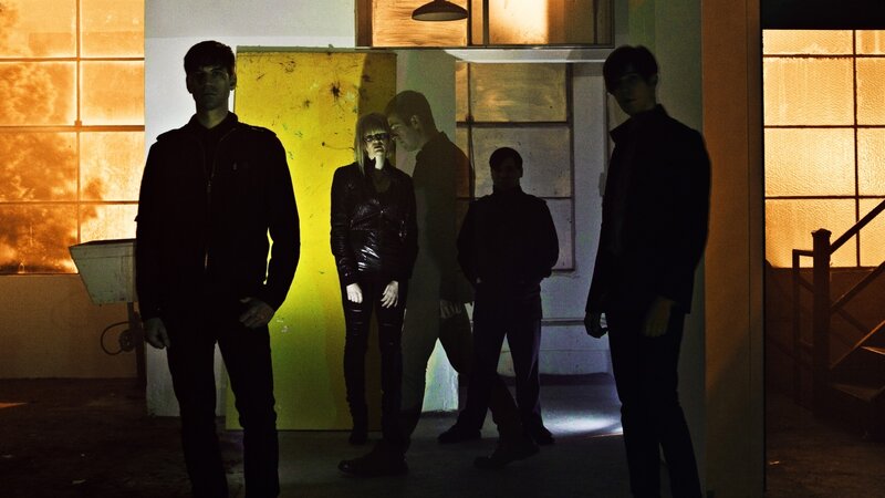 band in dimly lit room