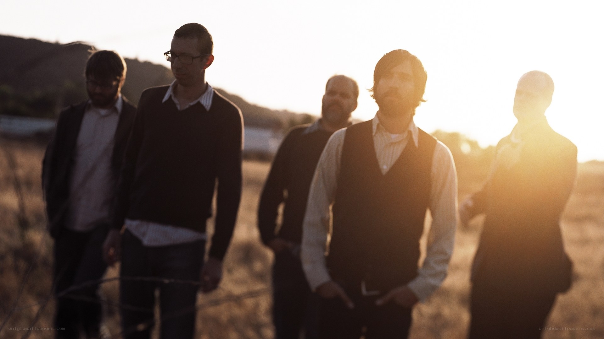 band in field at sunset