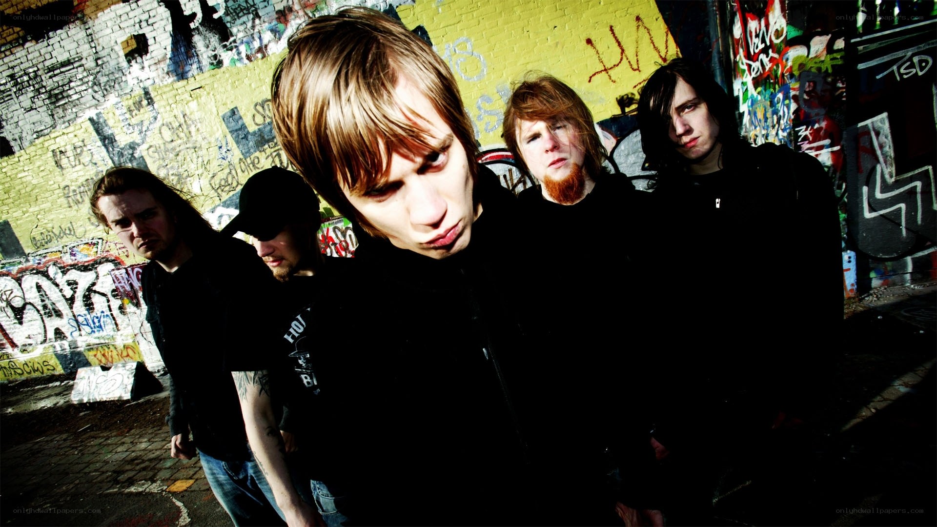 band in front of graffiti wall