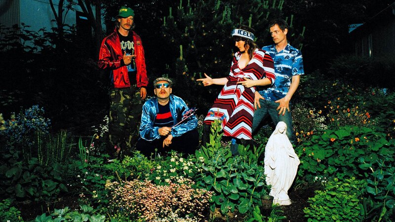 band in garden with statue