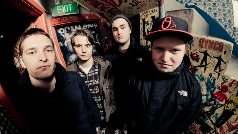 band in graffiti-covered room