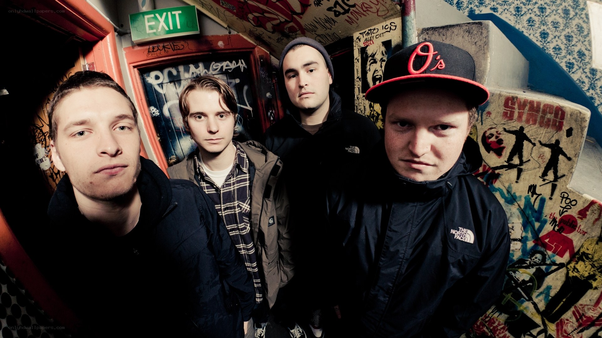 band in graffiti-covered room