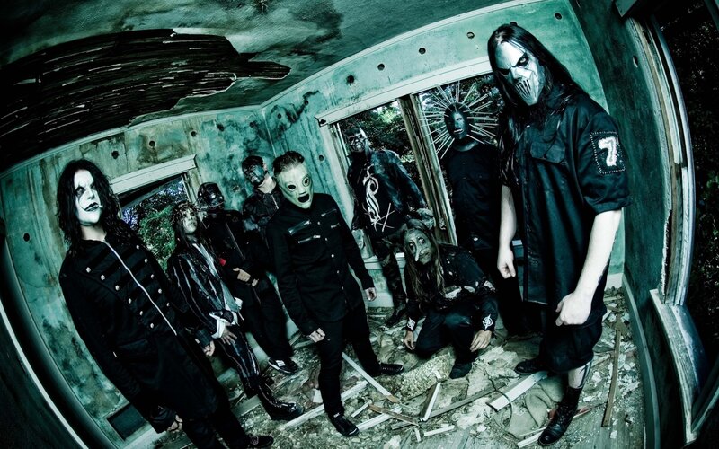 band in masks in ruined room