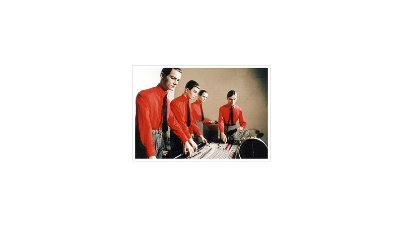 band in red shirts at mixing board