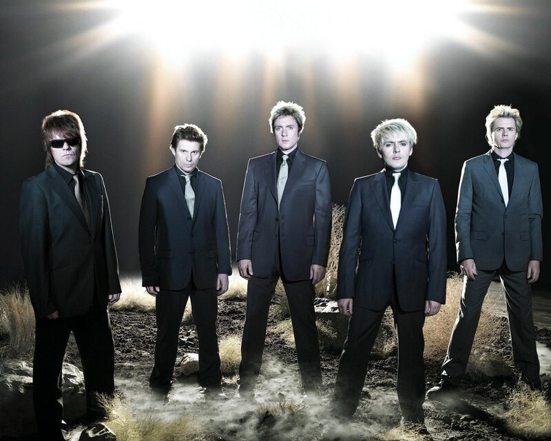 band in suits on rocky ground