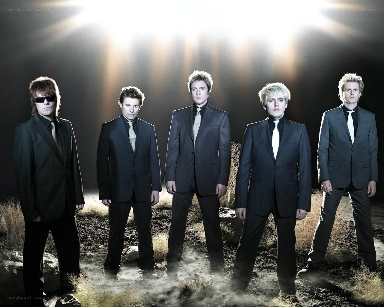 band in suits on rocky ground
