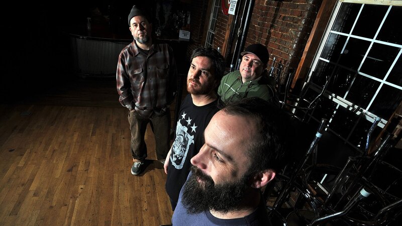band members in a dimly lit room