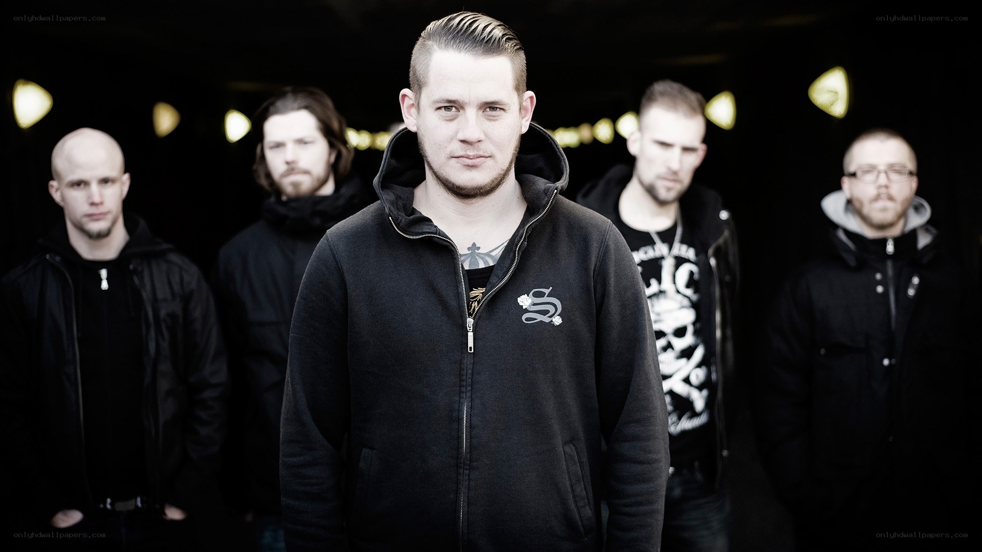band members in black hoodies