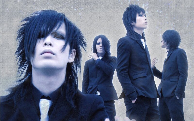 band members in black suits