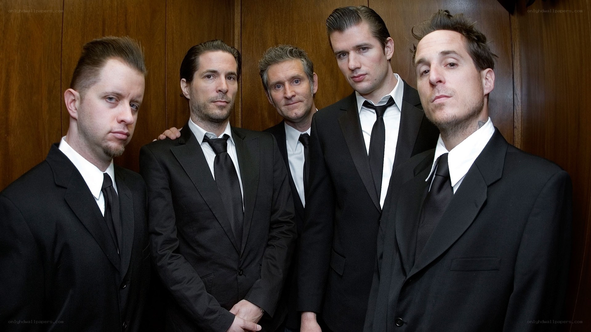 band members in black suits