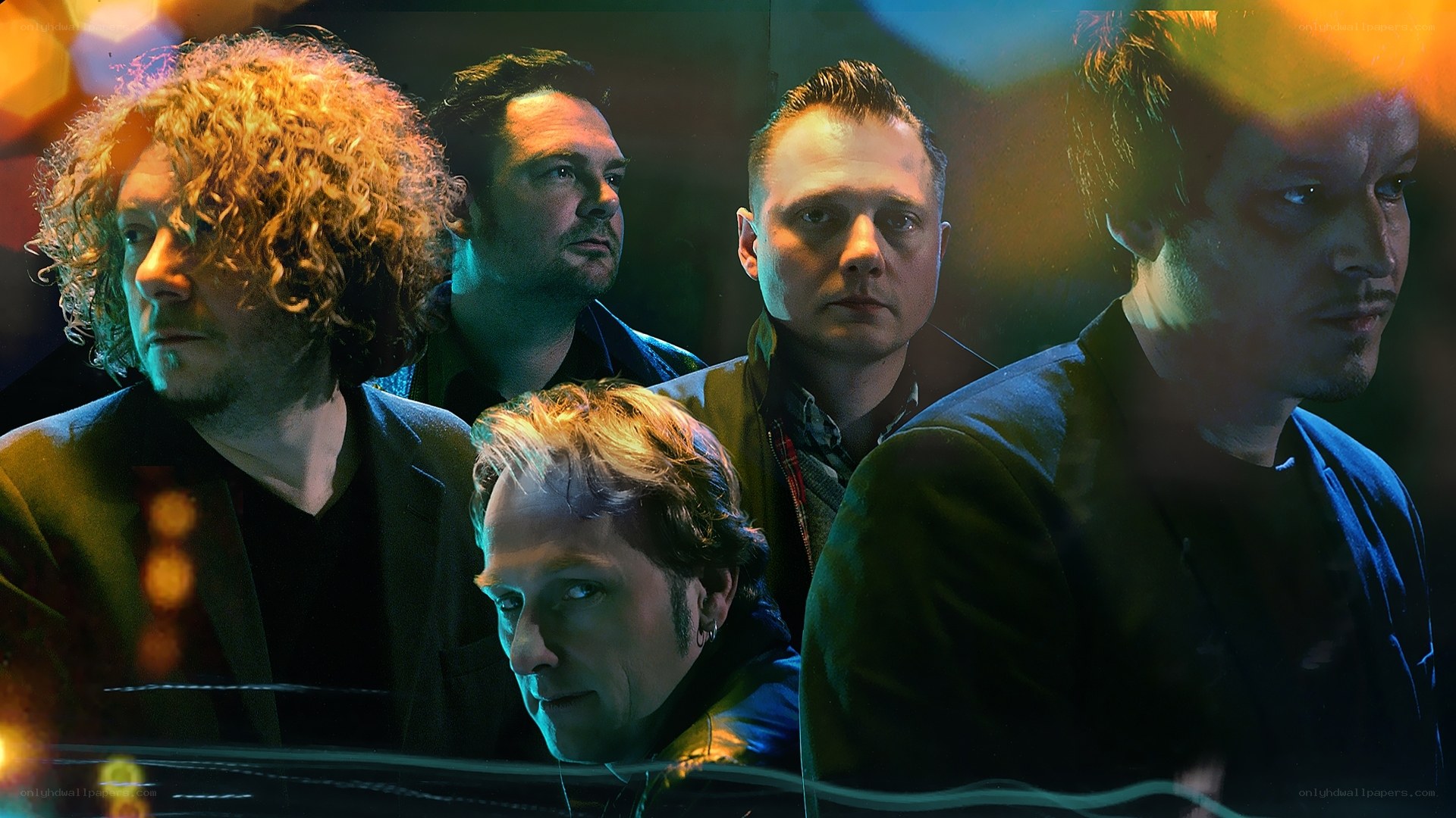 band members in colorful lighting