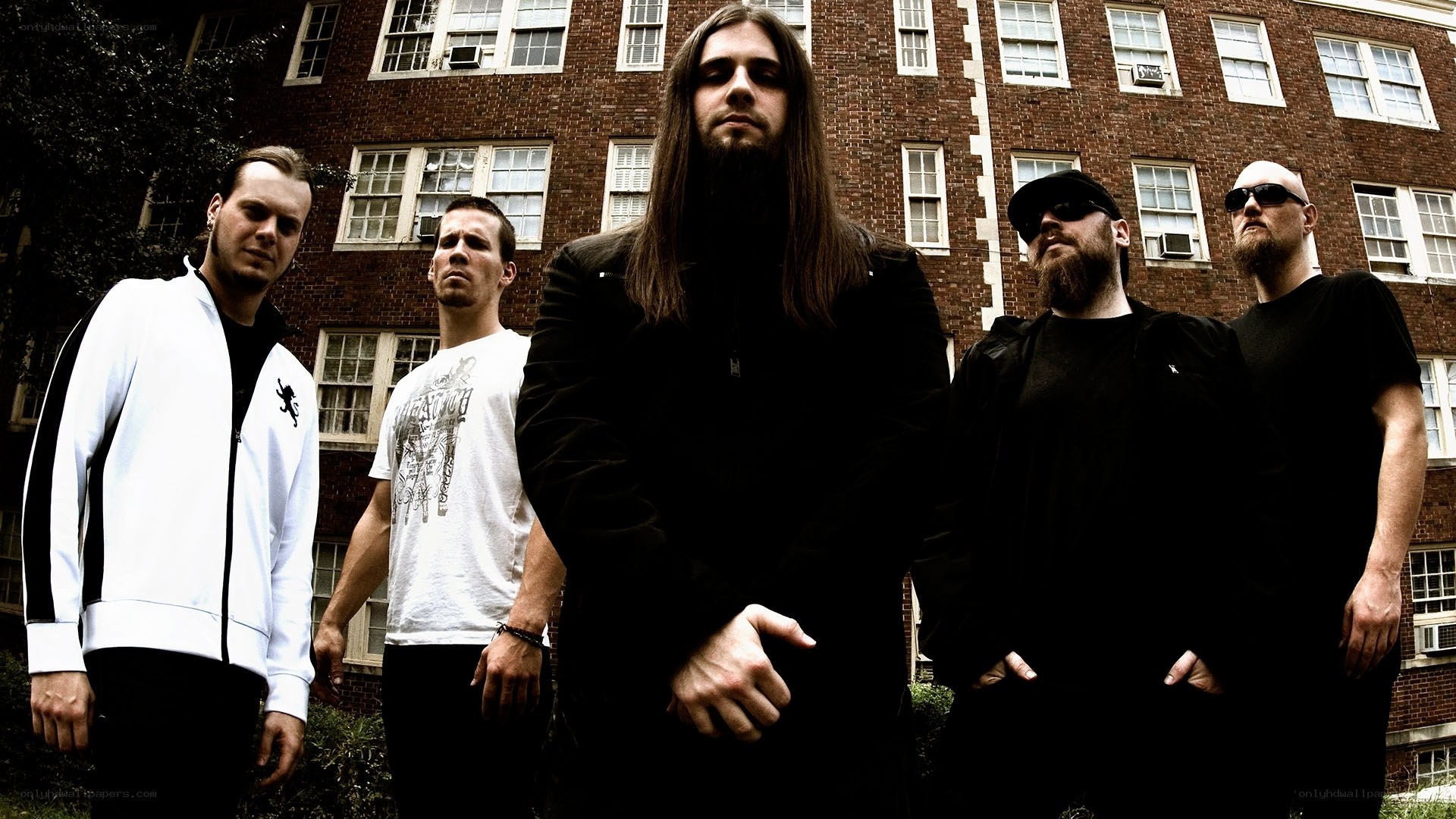 band members in front of brick building