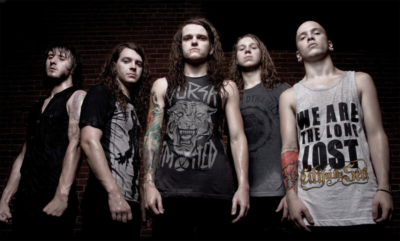 band members in front of brick wall