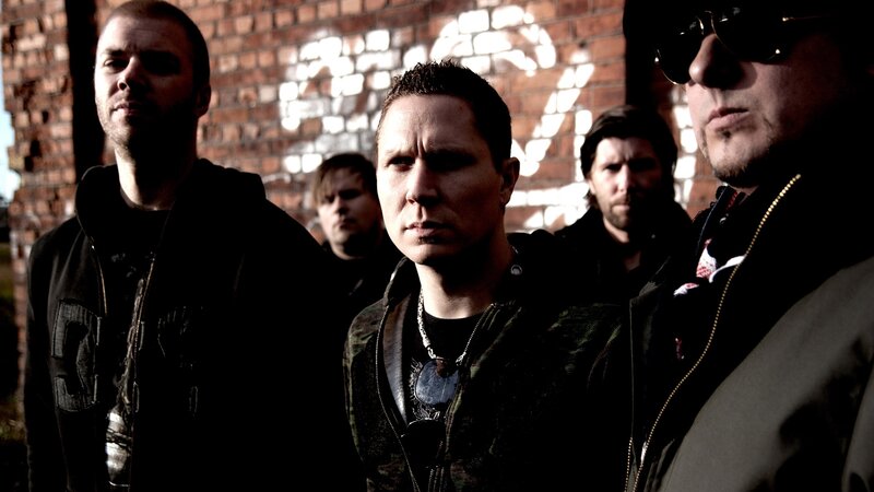 band members in front of brick wall