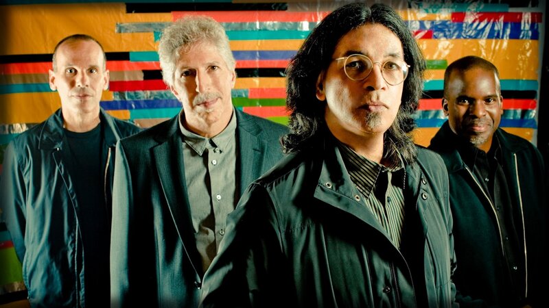 band members in front of colorful backdrop