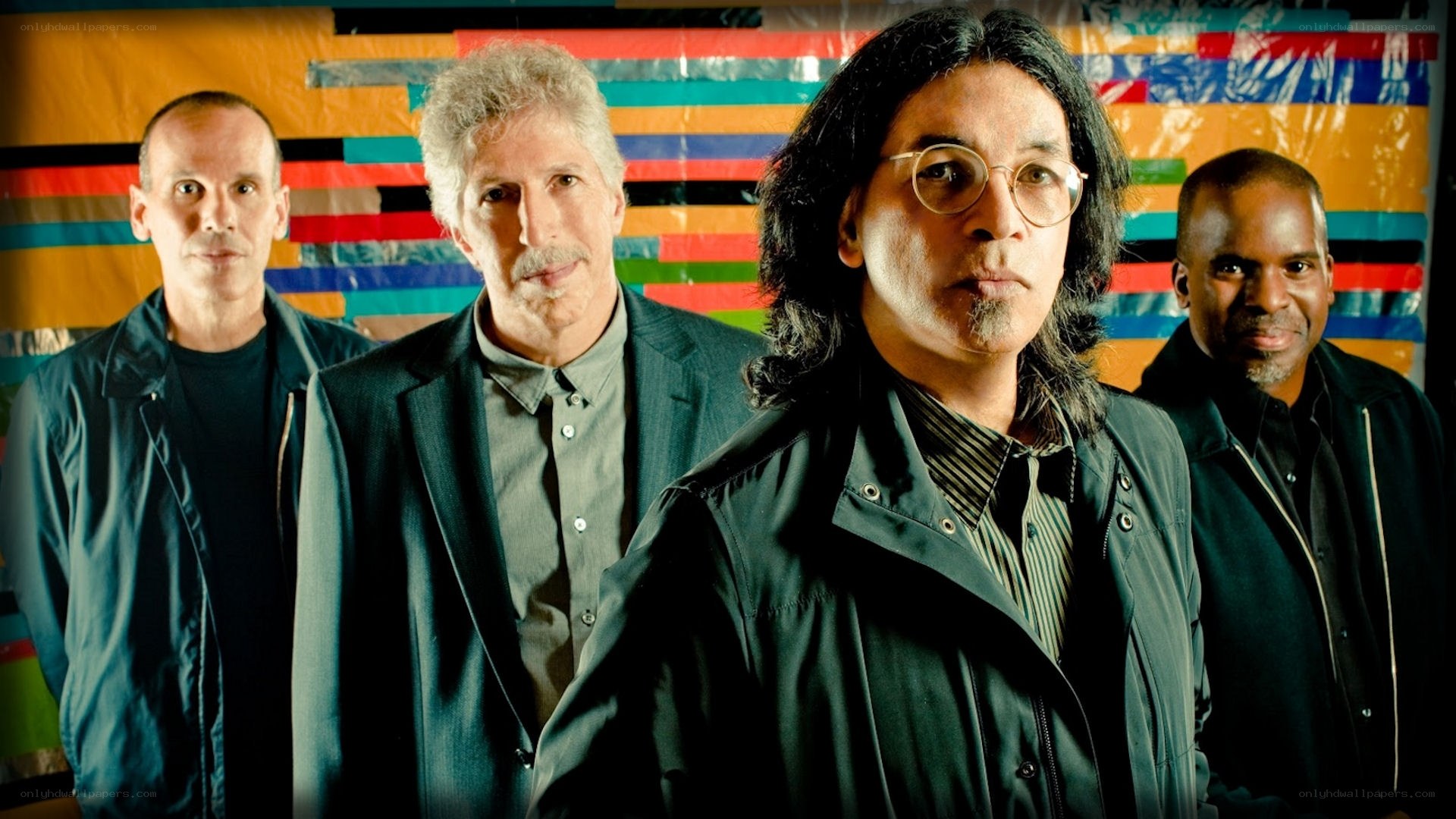 band members in front of colorful backdrop