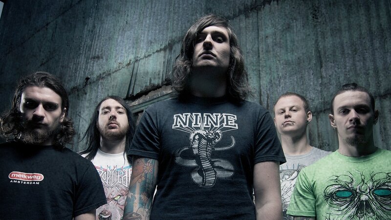 band members in front of concrete wall