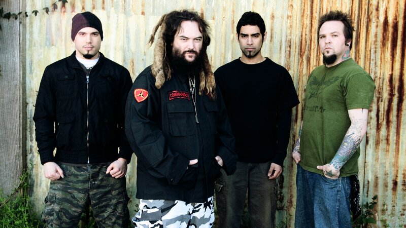 band members in front of corrugated metal
