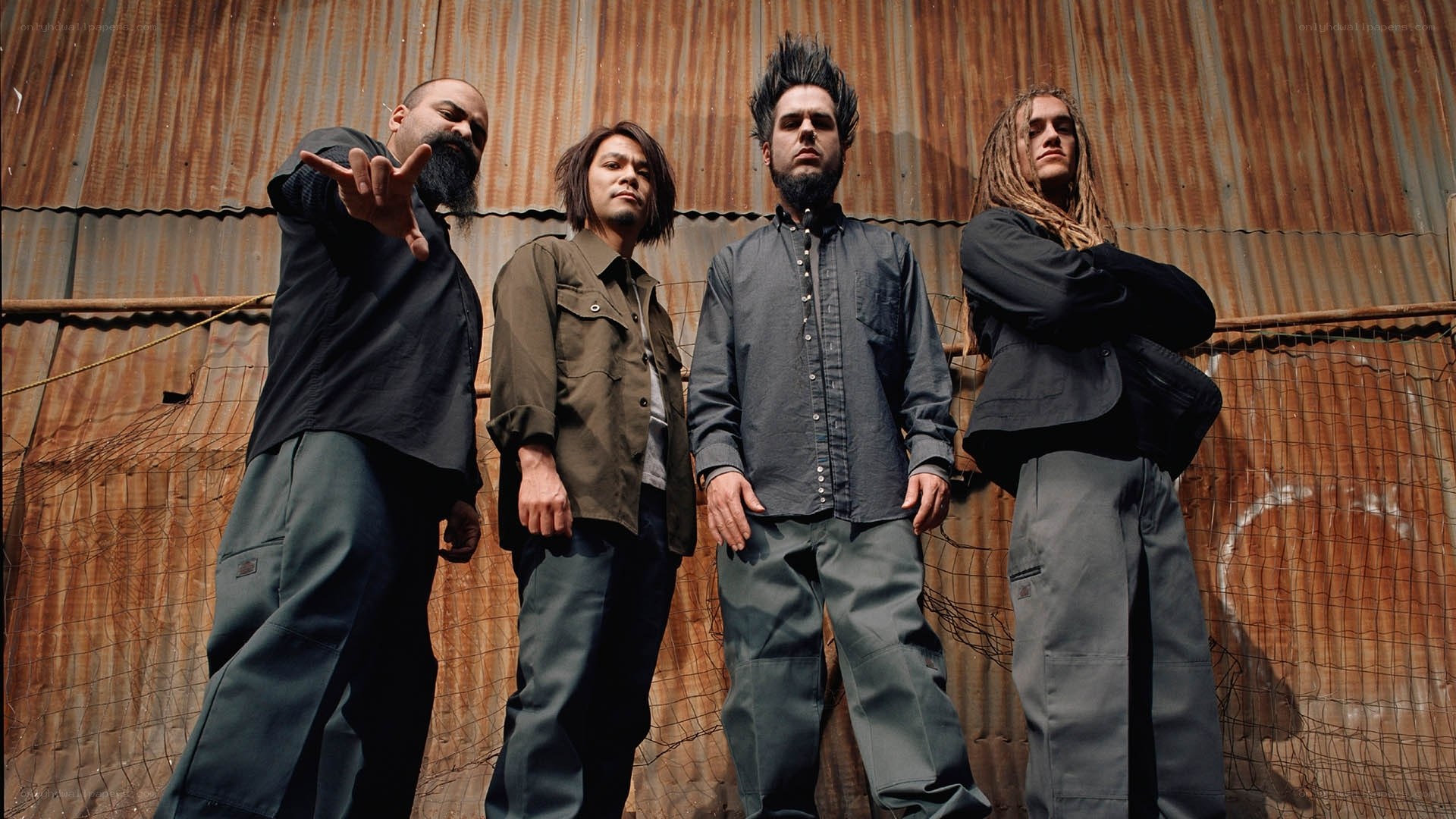 band members in front of corrugated wall
