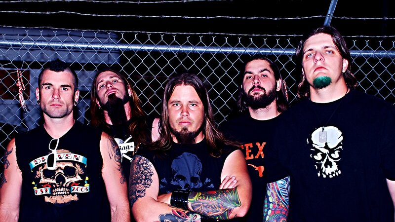 band members in front of fence