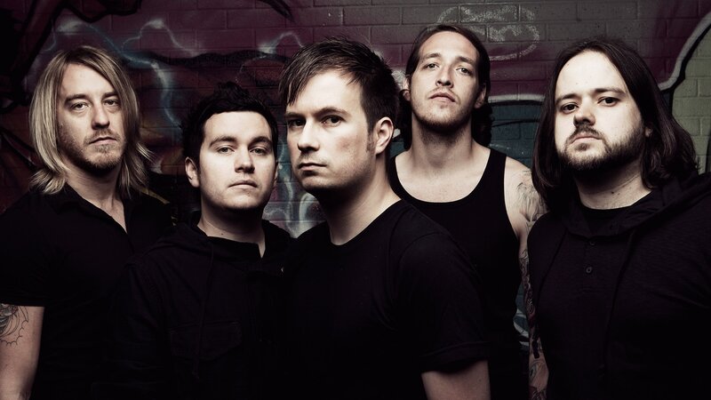 band members in front of graffiti wall