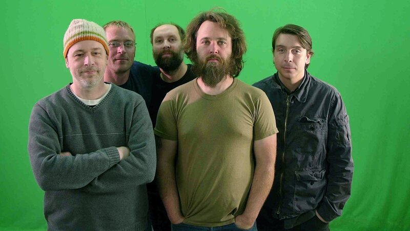 band members in front of green screen